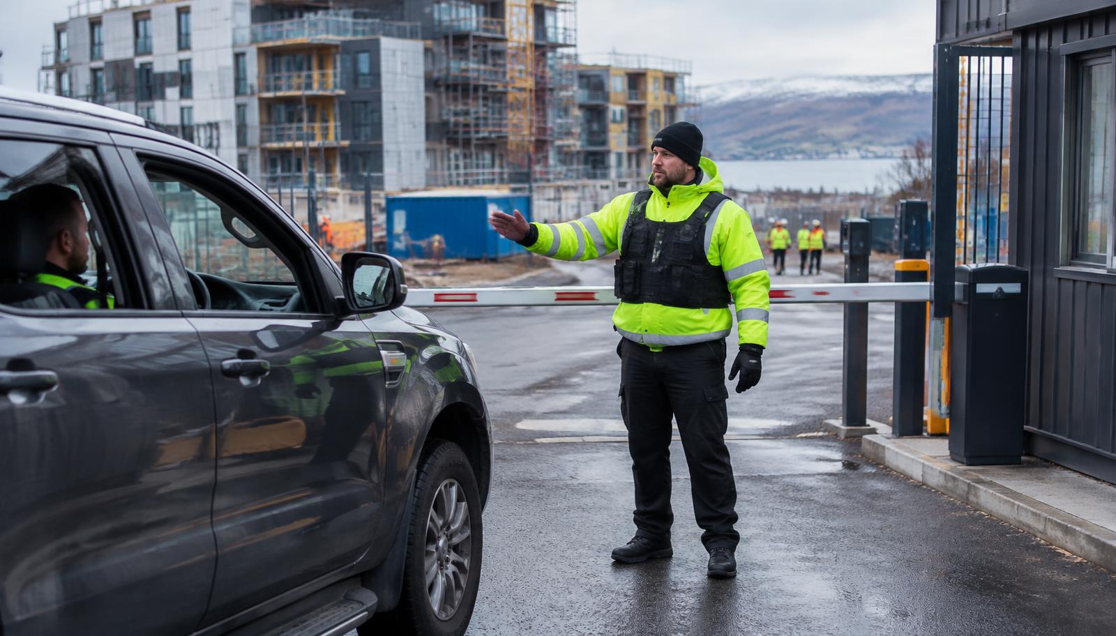 Security officer controlling vehicle access at a Scottish construction site